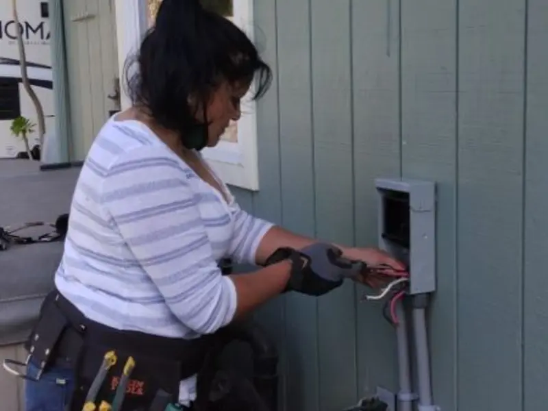 Licensed electrician wiring an exterior subpanel in Lamesa